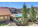 Community pool area with surrounding landscaping and building exterior visible at 904 Charo Pkwy # 525, Davenport, FL 33897