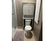 Small bathroom with toilet and storage cabinet at 12128 Sw 41St Pl, Ocala, FL 34481
