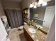 Bathroom with granite vanity and shower at 12128 Sw 41St Pl, Ocala, FL 34481