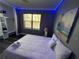 Bedroom with king-size bed and blue LED lighting at 12128 Sw 41St Pl, Ocala, FL 34481