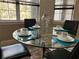 Glass dining table with four chairs in kitchen at 12128 Sw 41St Pl, Ocala, FL 34481