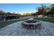 Stone fire pit in the backyard surrounded by brick pavers at 12128 Sw 41St Pl, Ocala, FL 34481