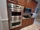 Double oven and microwave in a wood kitchen at 12128 Sw 41St Pl, Ocala, FL 34481