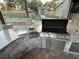 Outdoor kitchen with built-in grill and granite countertop at 12128 Sw 41St Pl, Ocala, FL 34481