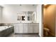 Double vanity bathroom with a soaking tub and a separate toilet at 2306 Amorie Dr, Kissimmee, FL 34746