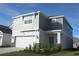 Two-story house with gray siding, white garage door, and landscaping at 2306 Amorie Dr, Kissimmee, FL 34746