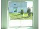 View of backyard through sliding glass doors showcasing green grass at 2343 Amorie Dr, Kissimmee, FL 34746
