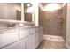 Bathroom boasts double vanity, large mirror, and walk-in shower at 2343 Amorie Dr, Kissimmee, FL 34746