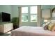 Bright bedroom with a queen-size bed and calming color scheme at 2343 Amorie Dr, Kissimmee, FL 34746