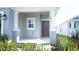 Charming front porch entryway with a dark brown door and white columns at 2343 Amorie Dr, Kissimmee, FL 34746