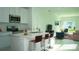 Open concept kitchen features island with seating, stainless steel appliances, and white cabinets at 2343 Amorie Dr, Kissimmee, FL 34746