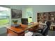 Home office with large desk, comfortable chair, and built-in shelving at 2343 Amorie Dr, Kissimmee, FL 34746