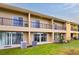 Townhome back with sliding glass doors leading to a patio and grass at 476 Lake Shore Pkwy, Davenport, FL 33896
