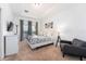 Main bedroom with a king-size bed, an armchair, and access to a balcony at 476 Lake Shore Pkwy, Davenport, FL 33896