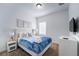 Bright bedroom with a queen bed, nightstands, and a large TV at 476 Lake Shore Pkwy, Davenport, FL 33896