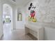 Bright entryway with Mickey Mouse wall art and console table at 476 Lake Shore Pkwy, Davenport, FL 33896