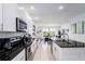 Open kitchen boasts stainless steel appliances and overlooks the living area at 476 Lake Shore Pkwy, Davenport, FL 33896