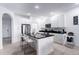 Modern kitchen with island, stainless steel appliances, and granite countertops at 476 Lake Shore Pkwy, Davenport, FL 33896