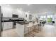 Modern kitchen with breakfast bar, stainless steel appliances, and an open floor plan at 476 Lake Shore Pkwy, Davenport, FL 33896