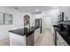 Modern kitchen with stainless steel appliances and island at 476 Lake Shore Pkwy, Davenport, FL 33896