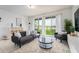 Bright living room with lake view, comfy seating, and stylish decor at 476 Lake Shore Pkwy, Davenport, FL 33896