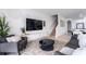 Open living room with stairs, TV, and comfy seating at 476 Lake Shore Pkwy, Davenport, FL 33896