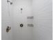 Spacious shower with white subway tile and brass fixtures at 476 Lake Shore Pkwy, Davenport, FL 33896