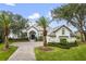 Stunning white two-story home with palm trees and manicured lawn at 6009 Lady Bet Dr, Orlando, FL 32819