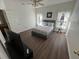 Spacious bedroom with a queen-size bed and dark wood floors at 612 Bloomingdale Dr, Davenport, FL 33897