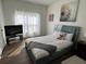 Bedroom with a large bed, a TV stand, and plenty of natural light at 612 Bloomingdale Dr, Davenport, FL 33897