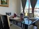 Bright dining room features a glass table with seating for six and large windows at 612 Bloomingdale Dr, Davenport, FL 33897