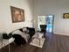 Living room with a sofa, armchair, coffee table, and access to a lanai and pool at 612 Bloomingdale Dr, Davenport, FL 33897