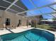 Screened-in pool area with plenty of space for relaxation and entertainment at 612 Bloomingdale Dr, Davenport, FL 33897