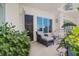 Private balcony with seating and lush greenery at 100 S Eola Dr # 1411, Orlando, FL 32801
