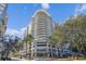 Modern high-rise building with palm trees and city views at 100 S Eola Dr # 1411, Orlando, FL 32801
