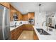 Modern kitchen with wood cabinets, stainless steel appliances and a large island at 100 S Eola Dr # 1411, Orlando, FL 32801