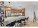 Modern kitchen with wood cabinets, stainless steel appliances, and an island with seating at 100 S Eola Dr # 1411, Orlando, FL 32801