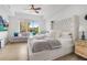 Spacious main bedroom with a king-size bed, light walls, and a sitting area at 100 S Eola Dr # 1411, Orlando, FL 32801