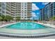 Resort-style pool with lounge chairs and cabanas at 100 S Eola Dr # 1411, Orlando, FL 32801