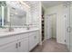 Double vanity bathroom with modern fixtures and a patterned tile accent wall at 1251 Citrus Landing Blvd, Davenport, FL 33837
