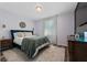 Bedroom with blue bed, green blanket, and wood dresser at 1251 Citrus Landing Blvd, Davenport, FL 33837