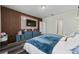 Bright bedroom with a comfortable bed, wood-look floors, and a stylish wood accent wall at 1251 Citrus Landing Blvd, Davenport, FL 33837