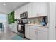 White kitchen with stainless steel appliances and a green wall at 1251 Citrus Landing Blvd, Davenport, FL 33837