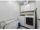 Convenient laundry room with washer, dryer, and overhead cabinets at 1251 Citrus Landing Blvd, Davenport, FL 33837