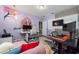 Home office with pink couch, desk, and anime wall art at 1251 Citrus Landing Blvd, Davenport, FL 33837
