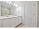 Bright bathroom with double vanity, large mirror, and walk-in shower at 1484 Discovery St, Davenport, FL 33896