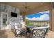 Outdoor kitchen and seating area with golf course view at 15939 Vetta Dr, Bella Collina, FL 34756