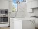 Modern kitchen with white cabinets, marble countertops, and stainless steel appliances at 1760 Mondrian Cir, Winter Park, FL 32789