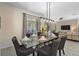 Bright dining room featuring a glass table and modern chandelier at 2759 Bookmark Dr, Kissimmee, FL 34746