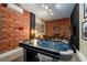 Basement game room with air hockey and brick wall at 2759 Bookmark Dr, Kissimmee, FL 34746